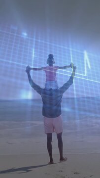 Vertical video: Father carrying child walking beach after extending arms, blue grid for ads