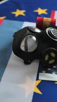 Nuclear Waste Barrels and Gas Mask on Tri-National Flags