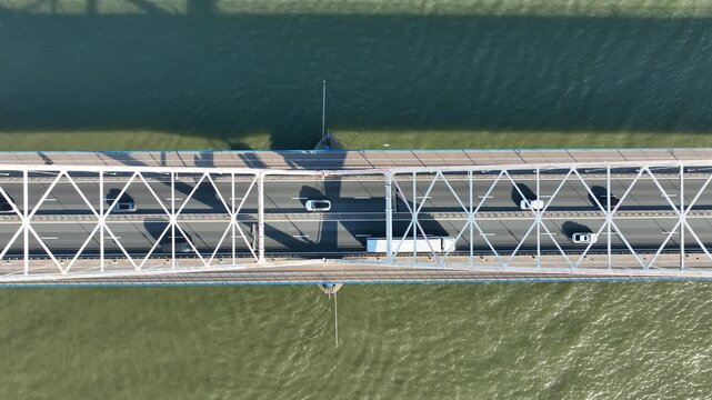 Top view of dense traffic on a bridge over a wide river in Europe