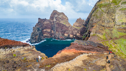 Hikers explore the stunning volcanic cliffs and turquoise waters of Ponta de Sao Lourenço, Madeira. A breathtaking Atlantic vista. © Viktor