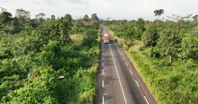 Cars Speeding in Silence Along Motorways Surrounded by Greenery in Abidjan, Africa