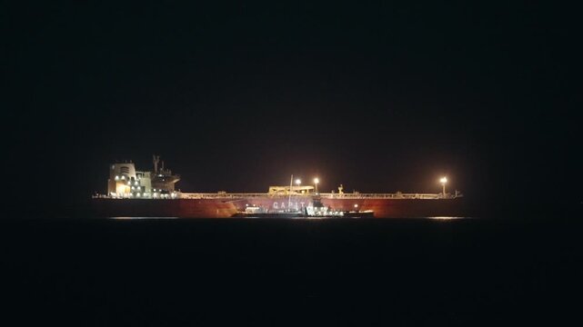 Tanker anchoring at night on the Pacific Ocean coastline Long Beach port 