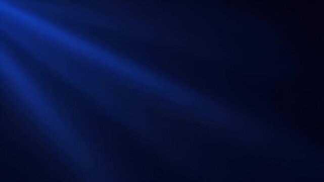 Vibrant blue light rays shine through darkness in a mesmerizing display