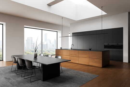 Modern minimalist kitchen interior with wooden island, sleek dark cabinetry, spacious dining area and large windows overlooking cityscape. 3D Rendering