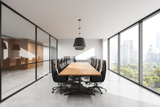 Modern conference room interior featuring long wooden table, ergonomic chairs, glass partitions and panoramic windows overlooking urban skyline in bright daylight. 3D Rendering
