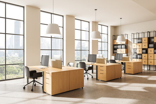 Modern bright open-plan office interior with wooden desks, large windows, ergonomic chairs and organized shelving in contemporary workspace. 3D Rendering