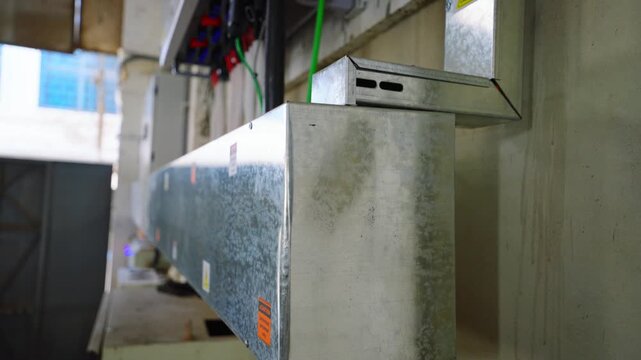 Galvanized steel trunking carrying electrical cables and wiring in an industrial setting