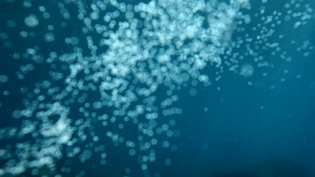 air bubbles slow  underwater coming up scenery dark blue and sun shine ocean scenery from scuba  divers backgrounds
