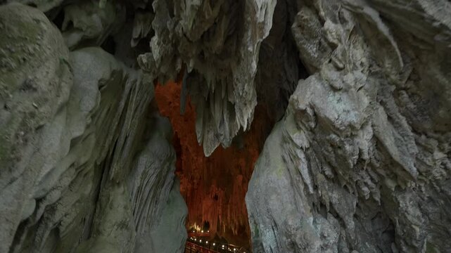 Titl down and push forwards at the entrance of a cave in Laos.