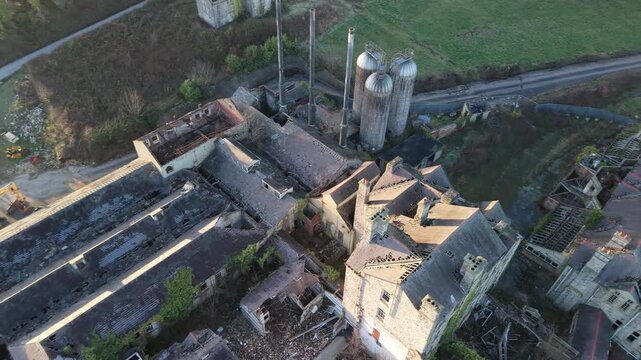 Rusty Silos And Pipes With The Ruins Of The North Wales Hospital In Denbigh, Wales, United Kingdom. Aerial Drone Shot