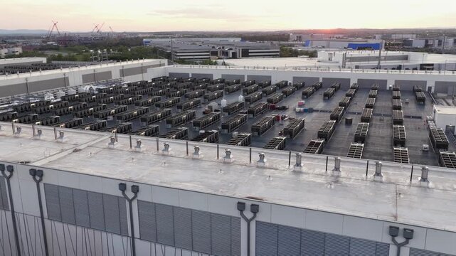 Large data center rooftop in Ashburn, Virginia at sunset with rows of server cooling units, showcasing modern cloud infrastructure, quiet industrial landscape and advanced AI technology. Aerial close