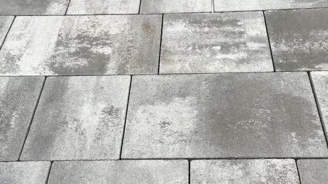 Gray rectangular paving stones with textured surface