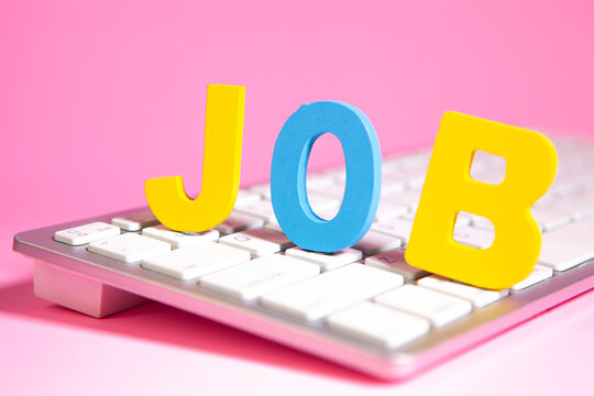 Job word on keyboard with pink background, business and education concept.