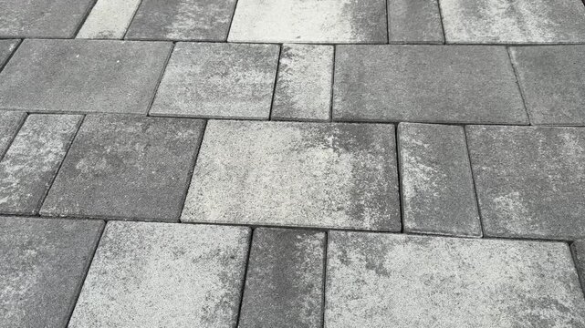 Gray concrete paving stones arranged in a pattern