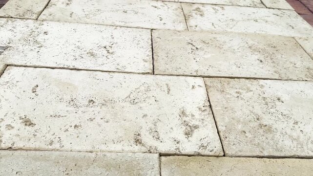 Weathered light stone tiles forming a textured surface