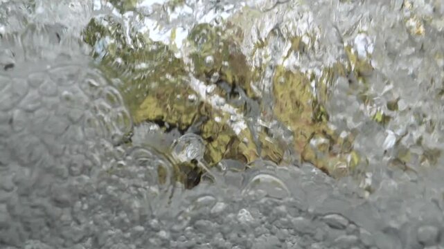bubbles underwater makes shapes in fast flowing river fresh water