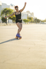 Fototapeta premium Woman roller skating enjoying outdoor activity at sunset