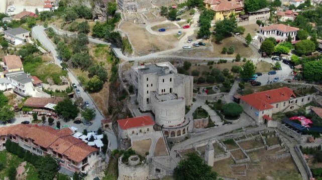 Stunning aerial footage showing the magnificent Kruje castle, a medieval fortress and historical landmark surrounded by the old town in Albania