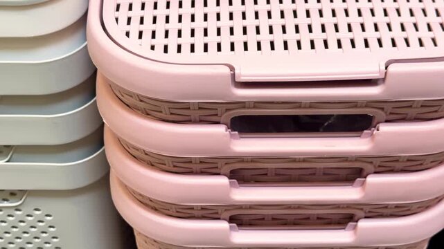 Stack of pink and gray plastic baskets