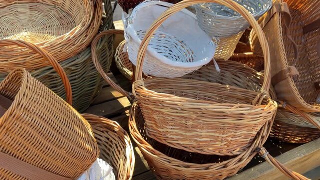 Collection of woven wicker baskets stacked outdoors