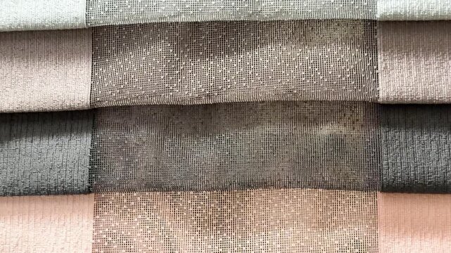 Fabric samples in neutral colors with textured patterns