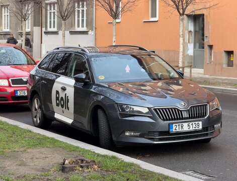 Dark Skoda Superb III of Bolt delivery company with its typical white circle logo