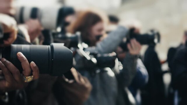 Photographers and paparazzi taking pictures on red carpet