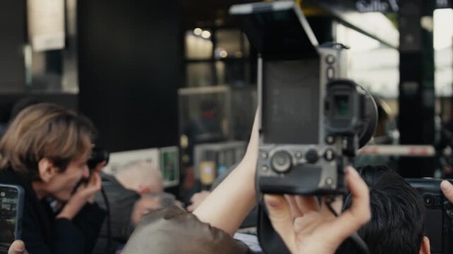 Photographers and paparazzi taking pictures at an event