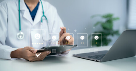 Doctor using tablet reviewing patient feedback rating interface with satisfaction icons...