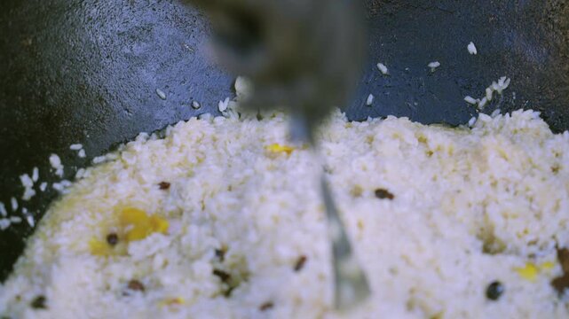 Female Chef in Glove Making a Well in Pilaf with Spoon, Close-Up