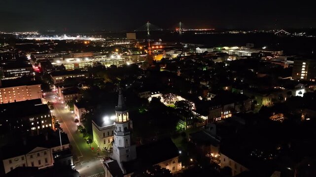 St. Michael's Church and Charleston, South Carolina skyline at night with drone video moving in.