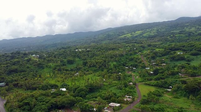 Aerial landscape view rising over the Garden Isle of Taveuni, Fiji in South Pacific with rugged green hilly terrain of shield volcano
