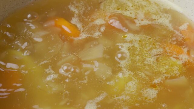 Soup with veggies and powdered chicken stock simmering nicely