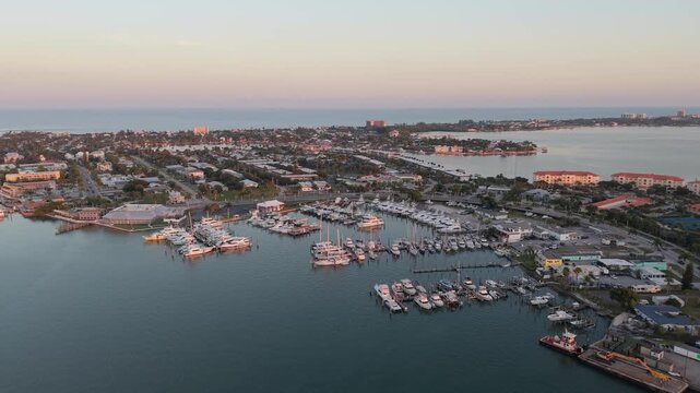 Cinematic aerial drone footage of the Fort Pierce City Marina, showcasing rows of boats and the scenic Indian River Lagoon in Florida.