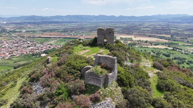 Forward aerial pass over ancient historic ruins and open terrain.