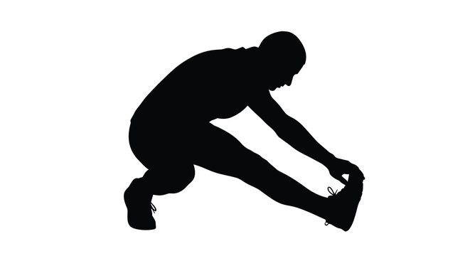 A man stretches preparing for exercise shown in dark silhouette