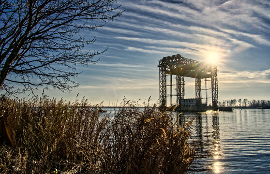 Karnin lift bridge ruins reflecting in water during winter sunset