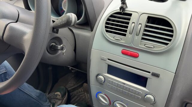 Driver pressing emergency hazard warning button