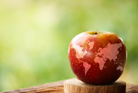 World map in apple fruit on natural background.World Food Day concept.