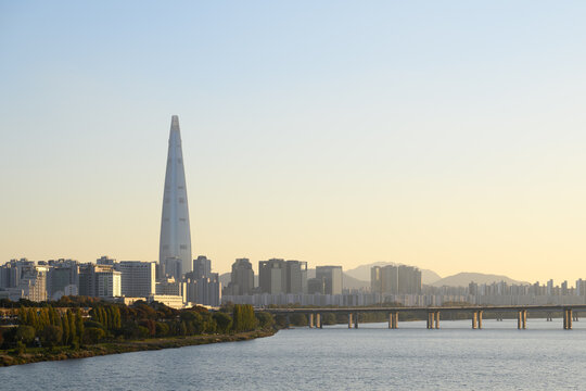 Sunset Seoul Skyline with Lotte World Tower and Grand Olympic Bridge Reflecting over Han River, South Korea