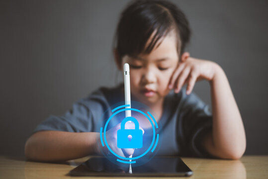 Young Asian girl using tablet with glowing padlock icon, concept of digital safety for kids, parental control, online security and cyber protection for children.