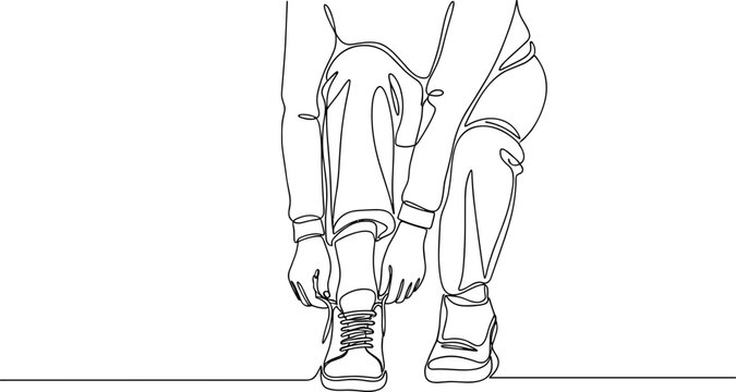 Person bending down to tie shoe.