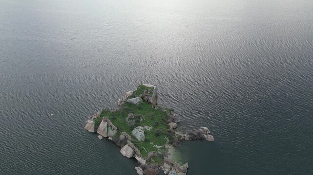 Drone footage captures the stunning natural beauty and historical significance of Bafa Lake Nature Park in Turkey. The aerial perspective showcases the serene waters of Bafa Lake nestled amidst rugged