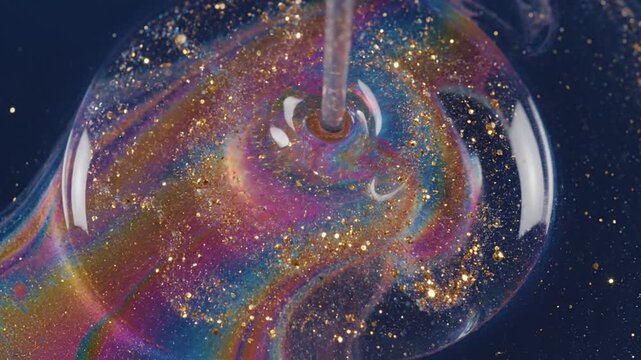 Dynamic iridescent liquid with glitter swirling on a dark background. Perfect for abstract motion graphics, creative video backgrounds, visual effects, and luxurious design elements, adding vibrant...