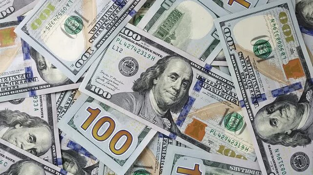 Finance background pile US Dollar cash banknotes. Top view currency exchange, banking wealth. Trade, investment, financial literacy concept. Professional stock footage monetary growth.