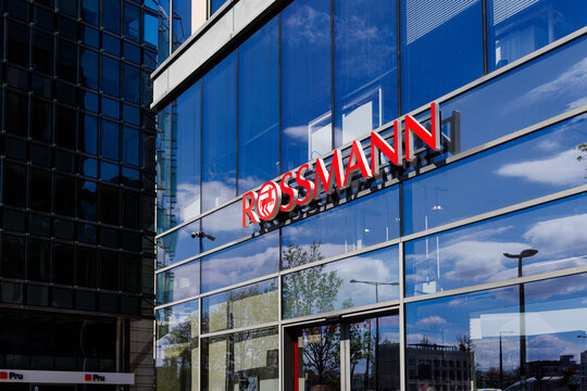 Warsaw, Poland &ndash; April 18, 2026: Rossmann logo on modern glass facade with reflections of surrounding buildings