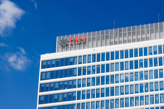 Warsaw, Poland &ndash; April 18, 2026: UBS logo on modern office building facade against blue sky in business district
