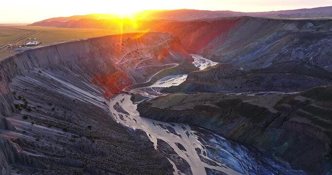 Aerial view of the spectacular Anjihai Grand Canyon with winding river and mountains during sunrise in Xinjiang, China