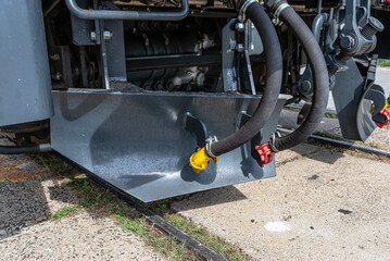 Train locomotive chassis with industrial hoses and couplings