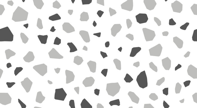 Scattered grey and dark grey irregular shapes on a white background